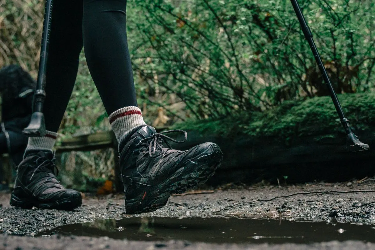 Hiking boots on a wet woodland path